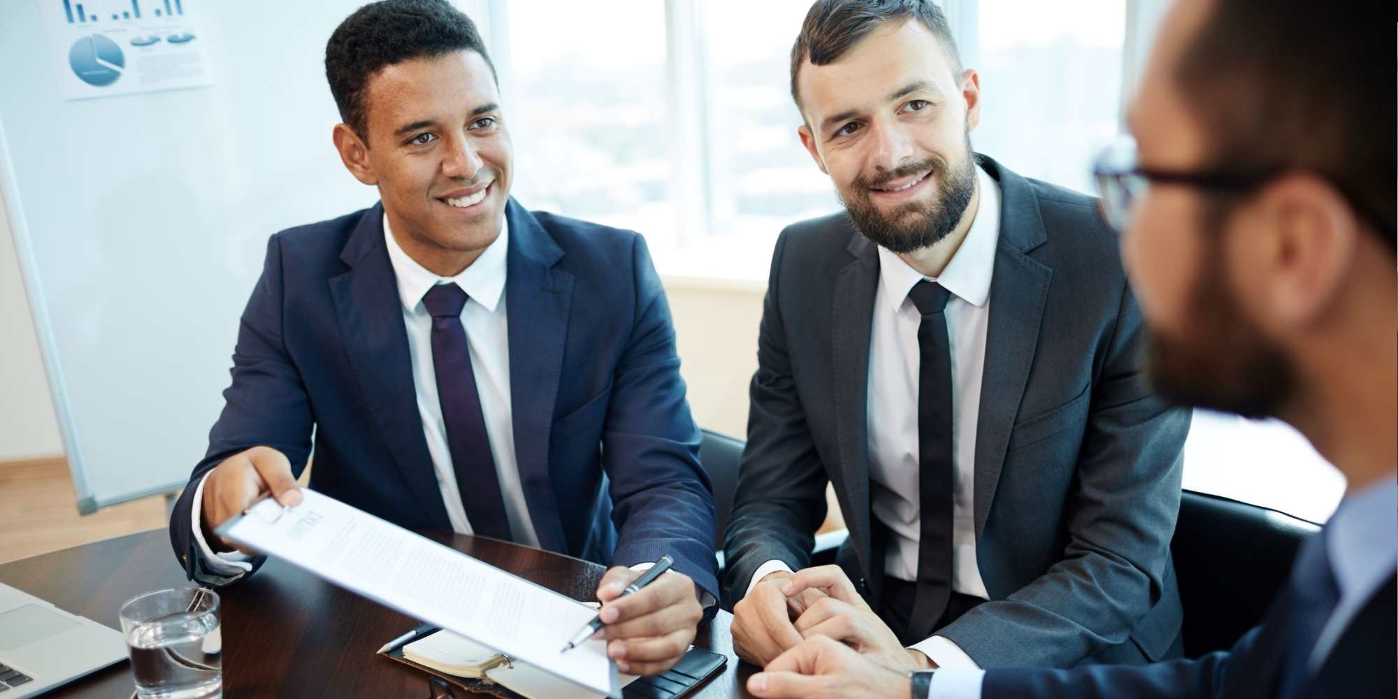 photo of business partners signing a fulfillment contract