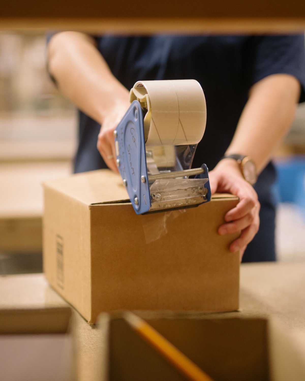 image of warehouse employee prepping a amazon package for FBA Prep